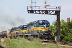 The Maple St. signal bridge frames DME 6094 and its two blue and gold sisters on train 632